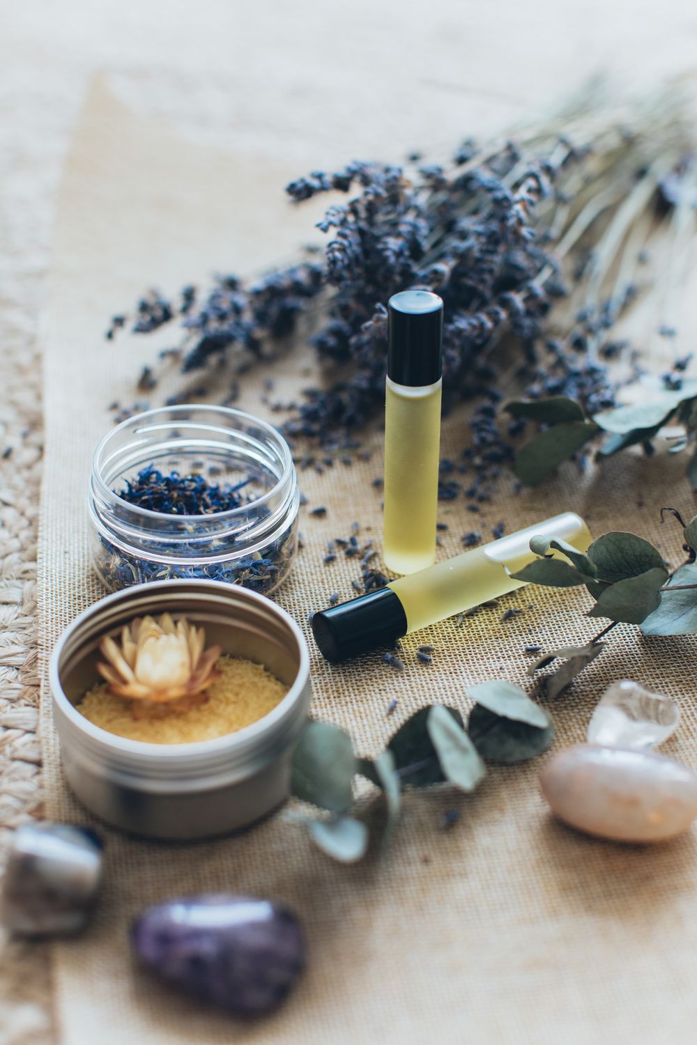 Aromatherapy oils with dried lavender and a candle