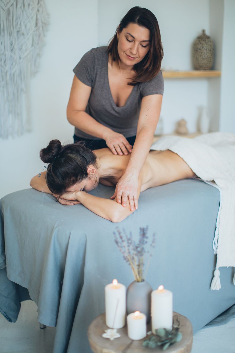 Therapist massaging a guest’s back with long strokes