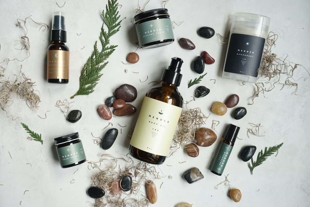 Massage oils, stones and botanicals laid out on a table