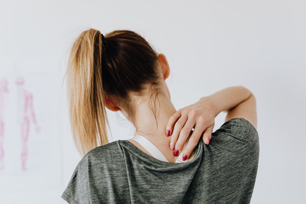 Woman holding her neck to show shoulder and neck tension
