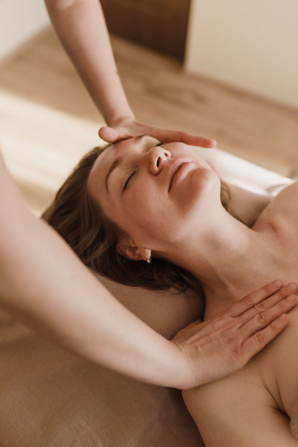 Therapist giving a gentle face and temple massage
