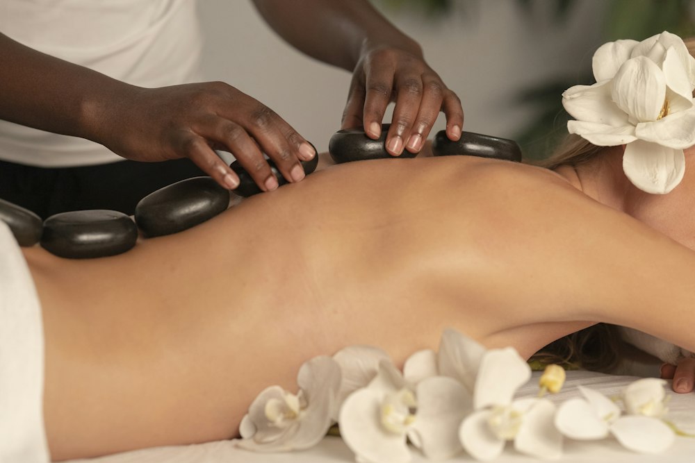Warm basalt stones placed along the back during a massage